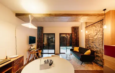 a living room with a couch and a table at Citta di Lume Suites & Lofts in Porto-Vecchio