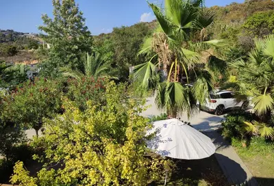 a white car parked in a parking lot with trees at Villa avec piscine et belle vue mer proche des plages et commerces in Porticcio