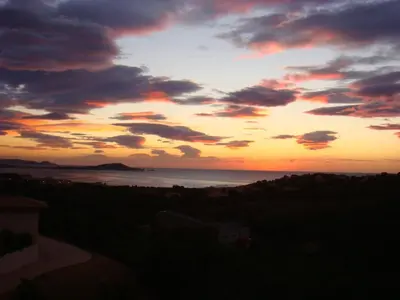 a sunset over the ocean with the sky at Villa avec piscine et belle vue mer proche des plages et commerces in Porticcio