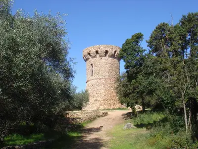 an old brick tower on a dirt road at Villa avec piscine et belle vue mer proche des plages et commerces in Porticcio