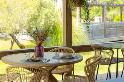 a table with plates of food on a patio at Résidence Casarina in Bonifacio