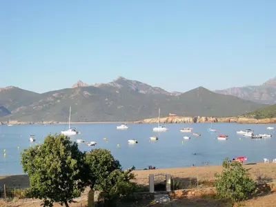 a bunch of boats in the water with mountains at Villa Fidiamare by Interhome in Galeria