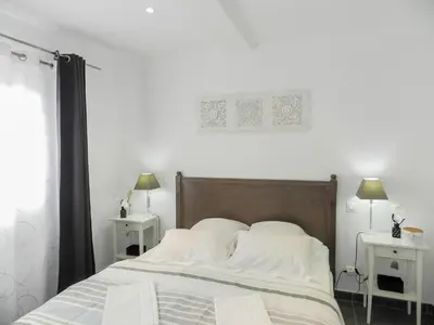 a bedroom with a bed with white sheets and two tables at Villa Fidiamare by Interhome in Galeria