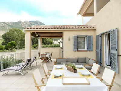 a patio with a table and chairs and a couch at Villa Fidiamare by Interhome in Galeria
