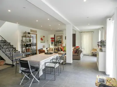 a dining room and living room with a table and chairs at Villa Fidiamare by Interhome in Galeria