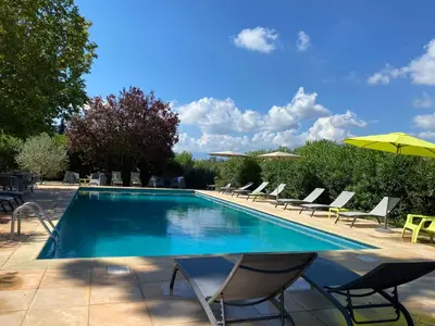 a swimming pool with lounge chairs and an umbrella at U-Casone in Linguizzetta