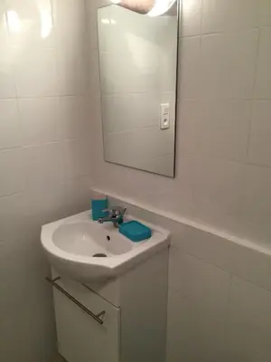 a white bathroom with a sink and a mirror at U-Casone in Linguizzetta