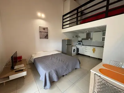 a small bedroom with a bed and a kitchen at U-Casone in Linguizzetta