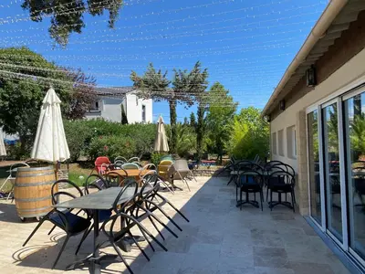 a patio with chairs and tables and umbrellas at U-Casone in Linguizzetta
