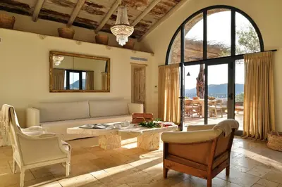 a living room with a couch and a table at Domaine Les Oliviers de Palombaggia in Porto-Vecchio