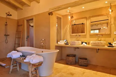 a bathroom with two sinks and a bath tub at Domaine Les Oliviers de Palombaggia in Porto-Vecchio