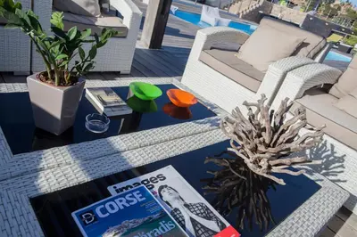 a coffee table with a magazine on top of it at Chambres d'hôtes Casa di l'Oru in Porto-Vecchio