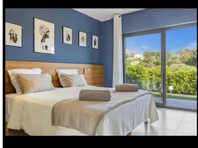a bedroom with a large bed with a large window at Chambres d'hôtes Casa di l'Oru in Porto-Vecchio