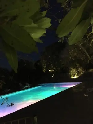 a lit up swimming pool at night at Thalassa in Sainte-Lucie de Porto-Vecchio