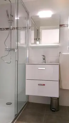a white bathroom with a sink and a shower at Domaine de Saint Pierre in Cargèse