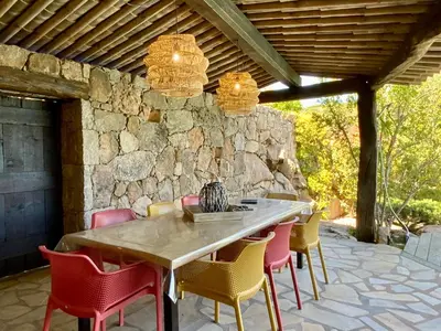 a kitchen with gray cabinets and a window and a sink at Concadoro in Porto-Vecchio