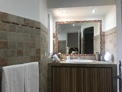 a bathroom with a sink and a mirror at Concadoro in Porto-Vecchio