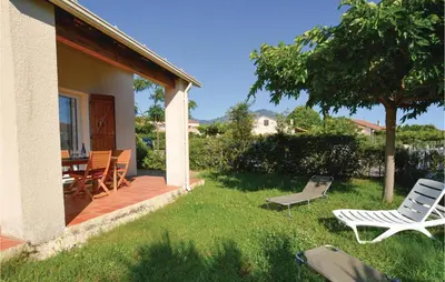 a patio with chairs and a table and a tree at Nice Home In Prunete With Wifi in Prunete