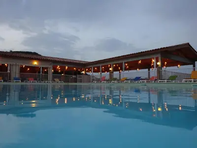 an empty swimming pool in front of a building at Camping Mozziconaccio in Sainte-Lucie de Porto-Vecchio