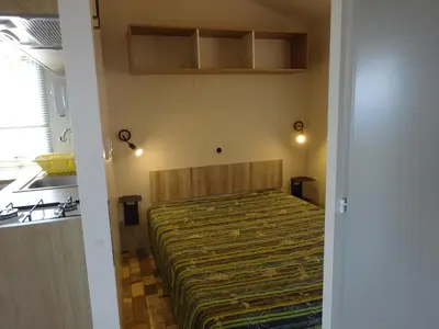 a small bedroom with a bed in a room at Camping Mozziconaccio in Sainte-Lucie de Porto-Vecchio