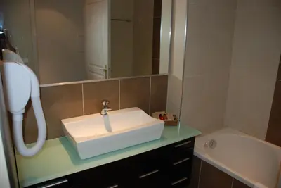 a bathroom with a sink and a mirror at Hôtel A Madonetta in Bonifacio