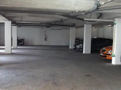 an empty parking garage with two cars parked in it at Hôtel A Madonetta in Bonifacio