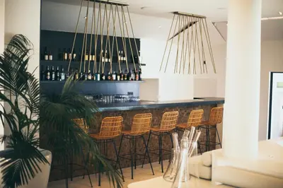 a bar with a bunch of bar stools at Résidence Terra Marina in Bonifacio