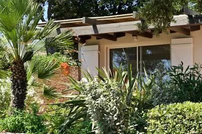 a house with a bunch of plants in front of it at Résidence Terra Marina in Bonifacio