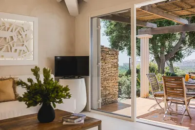 a living room with a sliding glass door to a patio at Résidence Terra Marina in Bonifacio