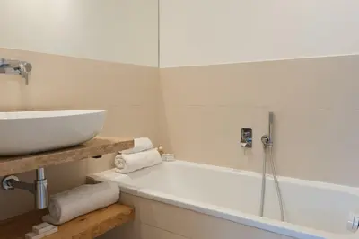 a bathroom with a sink and a bath tub at Résidence Terra Marina in Bonifacio