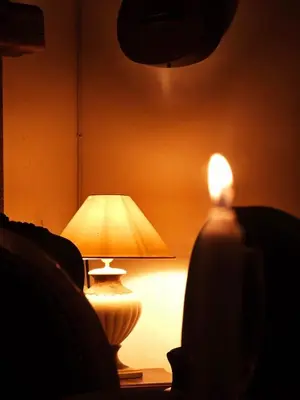 a lamp sitting on a table in a dark room at U Palazzu - Demeure de charme au centre de la Corse in Corte