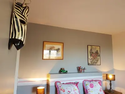 a room with two pillows and two pictures on the wall at Gîte L'Appart de Case Vanille in Sari Solenzara