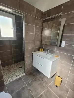 a bathroom with a white sink and a mirror at Gîte Tomasini in Monacia-dʼAullène