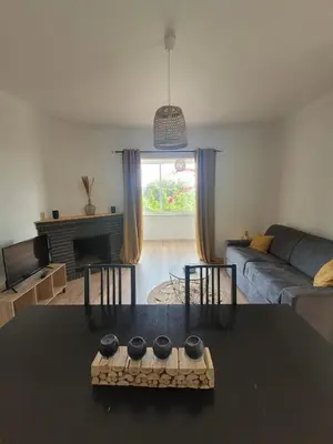 a living room with a table and a couch at Gîte Tomasini in Monacia-dʼAullène
