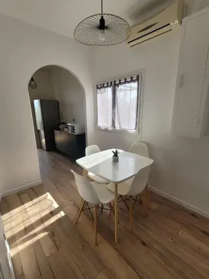 a dining room with a white table and chairs at Gîte Tomasini in Monacia-dʼAullène