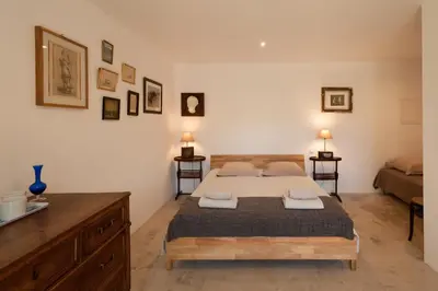 a bedroom with a bed and a dresser in it at Maison Tavolara in Porto-Vecchio