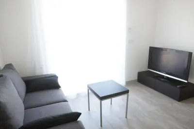 a living room with a couch and a table at T2 Campo Meta in Furiani
