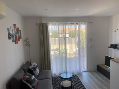 a living room with a couch and a large window at T2 Campo Meta in Furiani