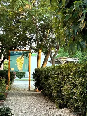 a sign in front of some bushes and trees at Le Clos des Arbousiers in Linguizzetta