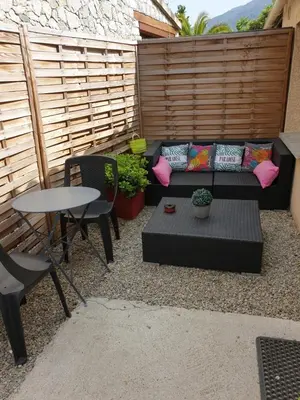 a patio with a couch and a table and chairs at Casa Petra in Corte
