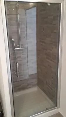 a shower with a glass door in a bathroom at Casa Petra in Corte