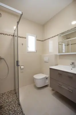 a bathroom with a toilet and a sink and a shower at Hôtel et Résidence Ta Kladia - Omigna in Cargèse