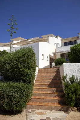 a stairway leading up to a white building at Hôtel et Résidence Ta Kladia - Omigna in Cargèse