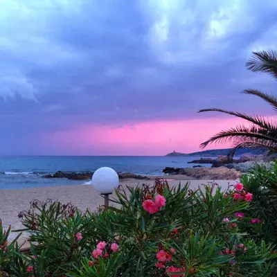 a view of the beach at sunset with a white ball at Hôtel et Résidence Ta Kladia - Omigna in Cargèse
