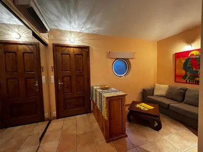 a living room with a couch and a table at Apartment Pioppa for 4 in Porto-Vecchio