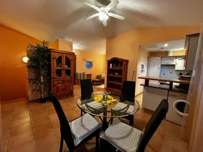a kitchen and dining room with a glass table and chairs at Apartment Pioppa for 4 in Porto-Vecchio