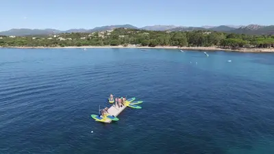 a person riding on a surfboard in the water at Kallisterra in Sainte-Lucie de Porto-Vecchio