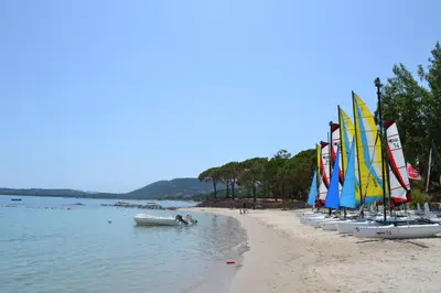 a row of sailboats lined up on a beach at Kallisterra in Sainte-Lucie de Porto-Vecchio