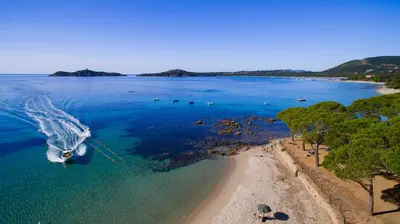 an aerial view of a beach with a boat in the water at Kallisterra in Sainte-Lucie de Porto-Vecchio