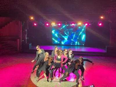 a group of women dancing on a stage at Kallisterra in Sainte-Lucie de Porto-Vecchio